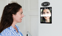 BioHotel GRMS Series room entrance bell — door 307 with facial recognition bell panel, guest face scan displayed on screen as woman approaches