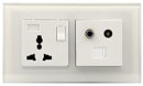Mil Series desk media hub — universal socket, TV aerial, and data ports on white glass